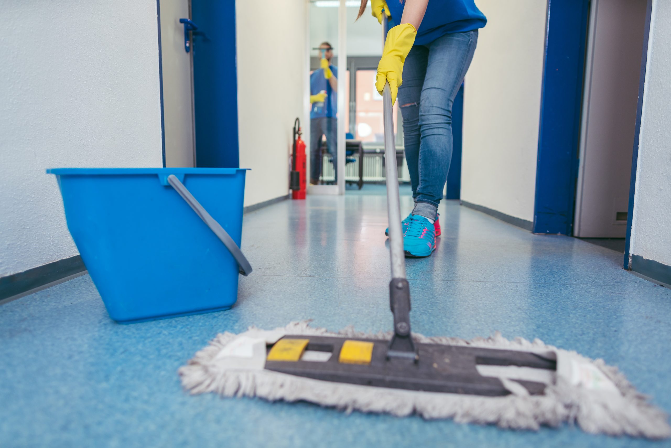 Close-up,Of,Cleaners,Moping,The,Floor,Of,A,Hall