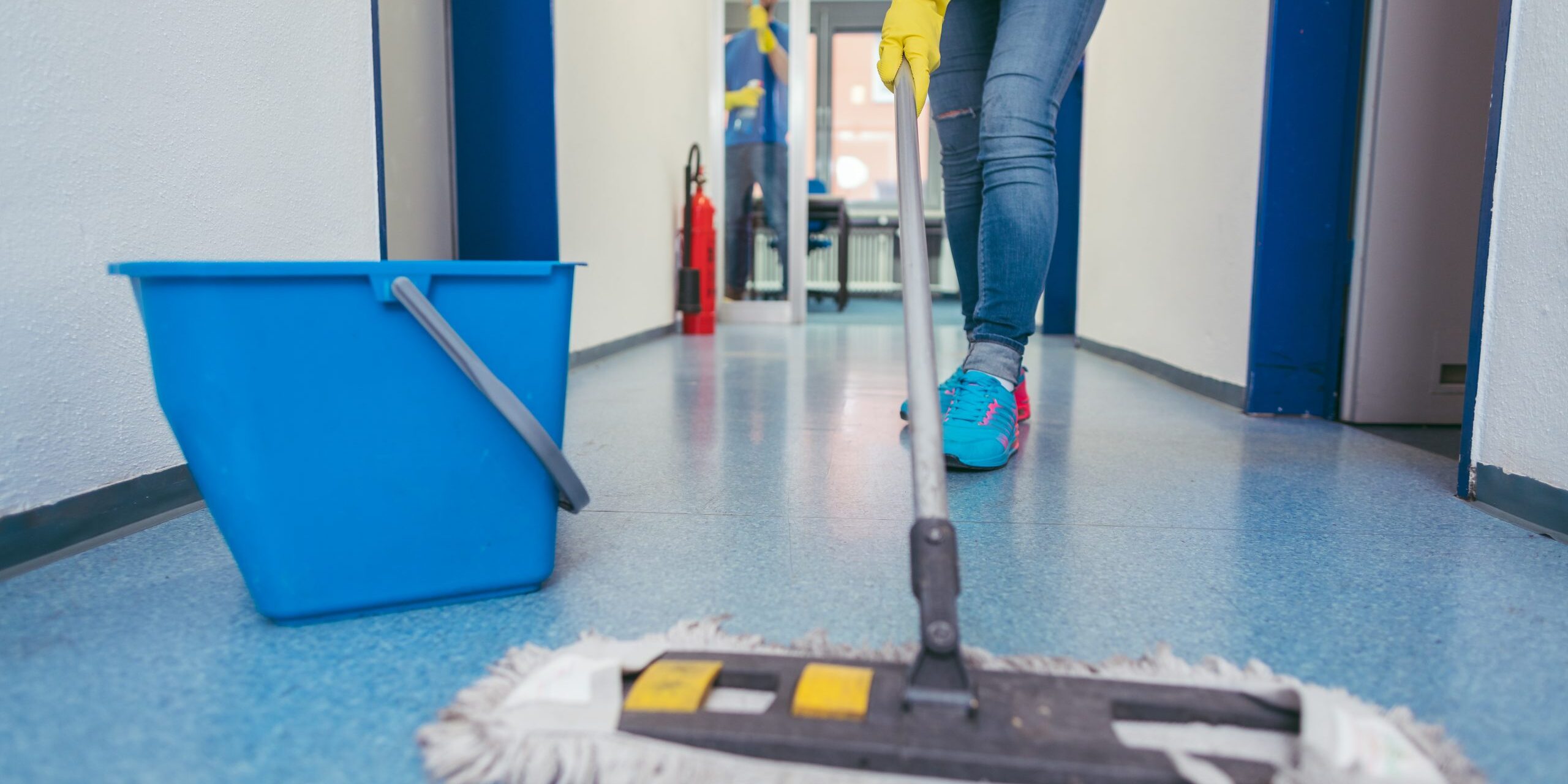 Close-up,Of,Cleaners,Moping,The,Floor,Of,A,Hall